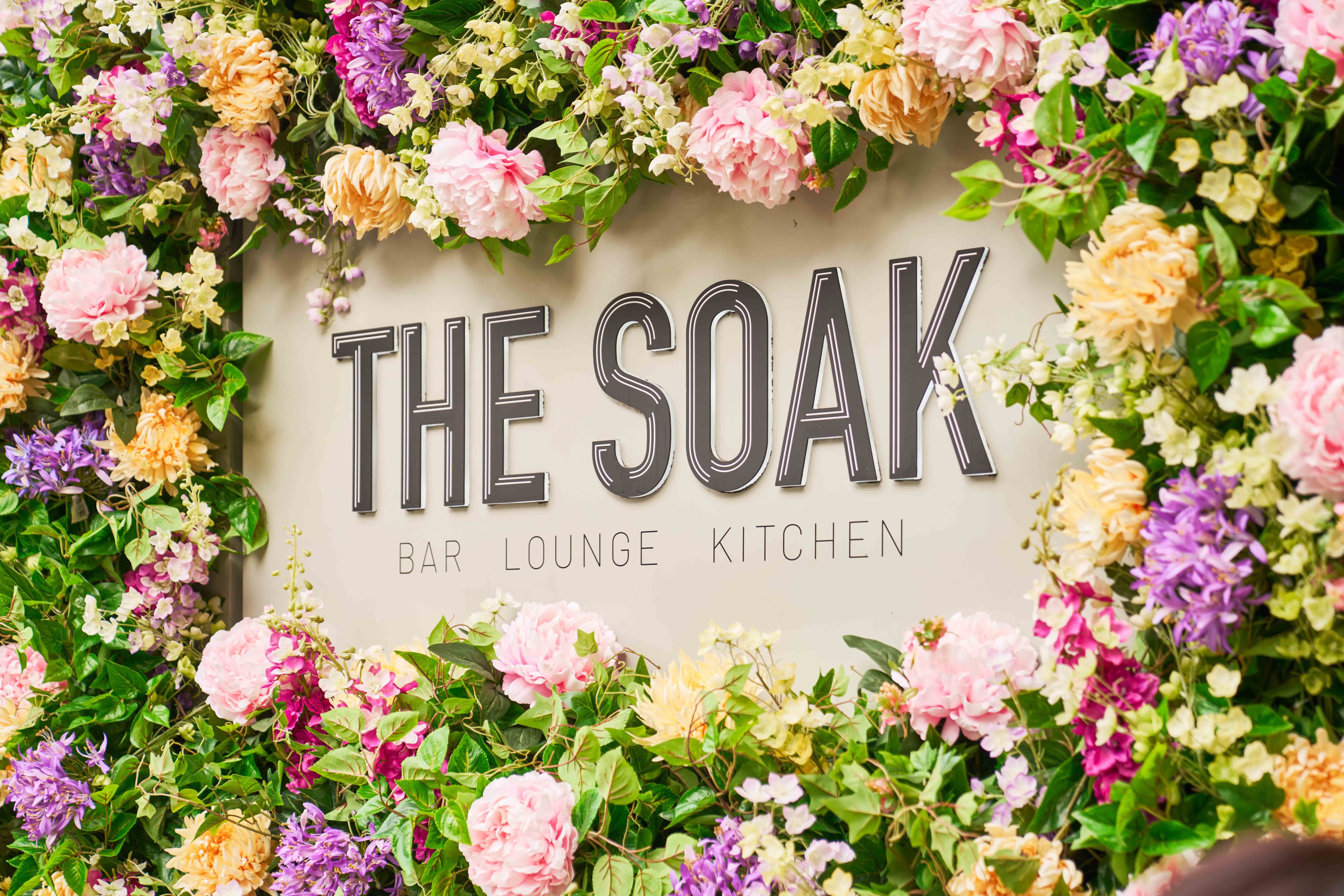 Soak Breakfast Mornings in London Blog Image Sign of Soak in font with flowers around
